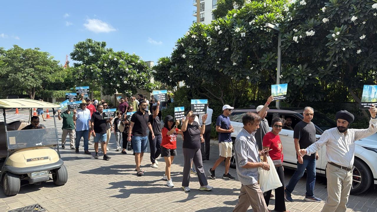Residents came together carrying placards and banners to demand accountability, transparency, and strict legal compliance in the management of their community.